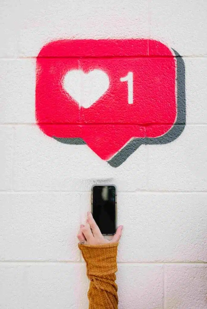Social Media like. A phone with a like above it on a wall