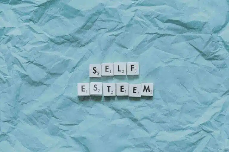 Scrabble tiles saying Self-Esteem on a blue background